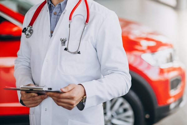 car doctor with stethoscope in a car showroom