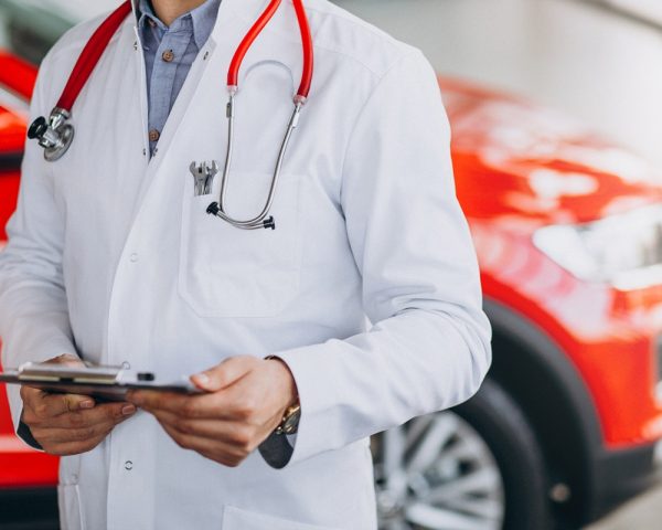 car doctor with stethoscope in a car showroom